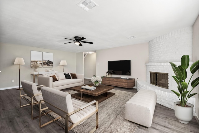 9110 Vickijohn Dr, Houston, TX 77031 - living area with wood finished floors, baseboards, a brick fireplace, and ceiling fan