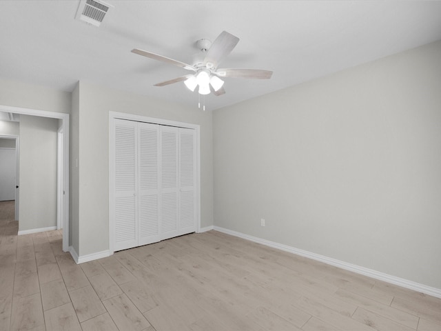 618 Forest Lake Dr, Seabrook, TX 77586 - unfurnished bedroom featuring light wood finished floors, a closet, baseboards, and a ceiling fan