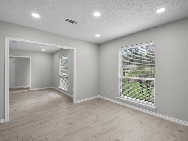 618 Forest Lake Dr, Seabrook, TX 77586 - unfurnished room with light wood finished floors, plenty of natural light, baseboards, a textured ceiling, and recessed lighting