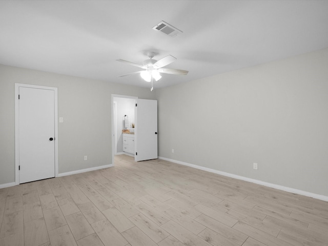 618 Forest Lake Dr, Seabrook, TX 77586 - unfurnished bedroom with light wood-type flooring, baseboards, and ensuite bath