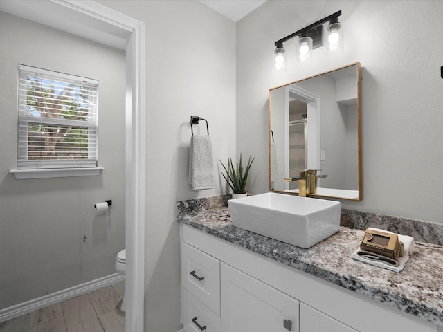 618 Forest Lake Dr, Seabrook, TX 77586 - bathroom featuring vanity, toilet, and baseboards