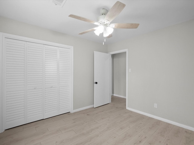 618 Forest Lake Dr, Seabrook, TX 77586 - unfurnished bedroom with light wood-style floors, a closet, baseboards, and a ceiling fan