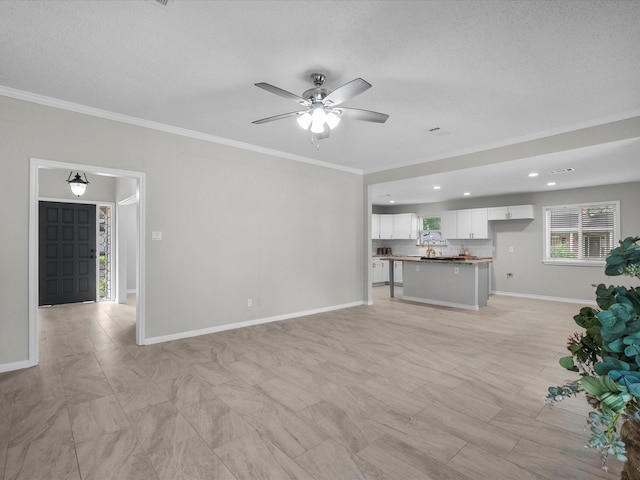 618 Forest Lake Dr, Seabrook, TX 77586 - unfurnished living room featuring ornamental molding, ceiling fan, baseboards, a textured ceiling, and recessed lighting