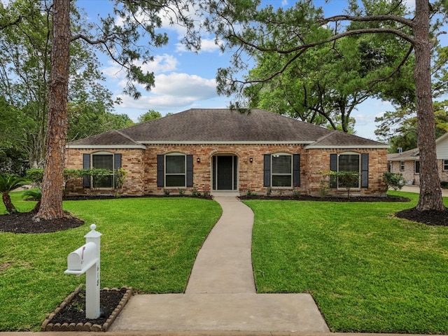 618 Forest Lake Dr, Seabrook, TX 77586 - single story home with a shingled roof, brick siding, and a front yard