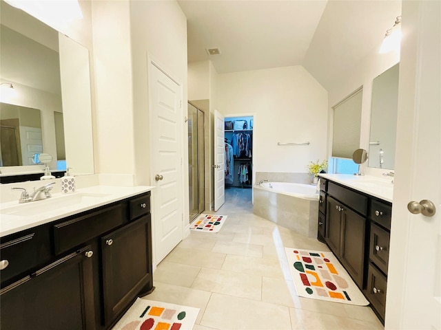 2507 Elmwood Trl, Katy, TX 77493 - bathroom with a bath, a shower stall, tile patterned floors, two vanities, and lofted ceiling