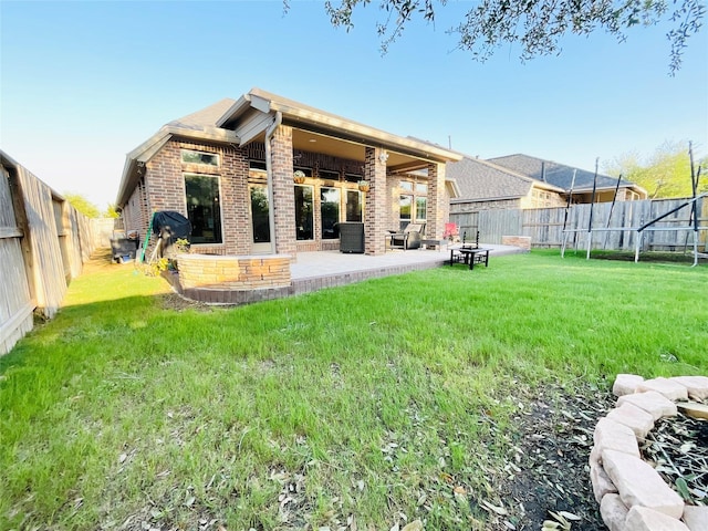 2507 Elmwood Trl, Katy, TX 77493 - rear view of house with brick siding, a fenced backyard, and a patio