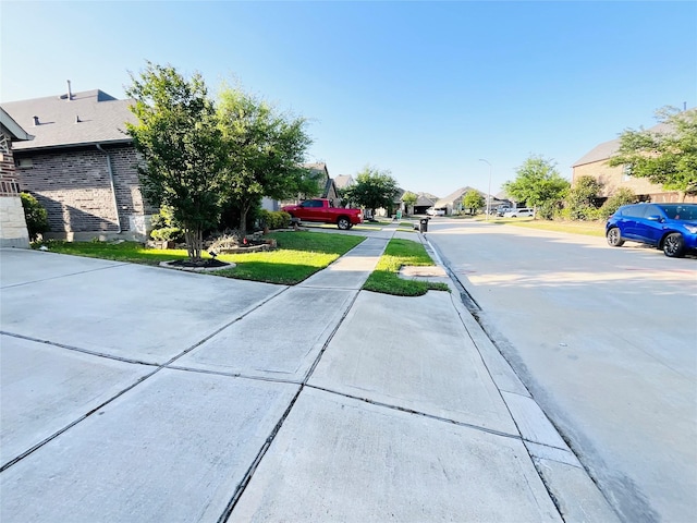 2507 Elmwood Trl, Katy, TX 77493 - view of concrete road featuring a residential view, street lighting, and sidewalks