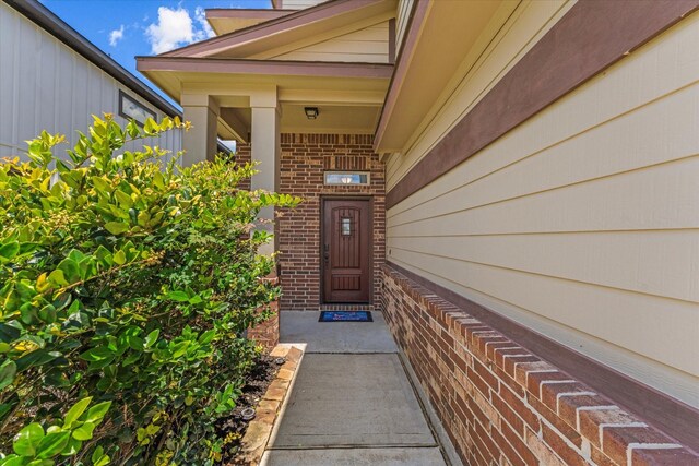 10744 S Lake Mist Ln, Willis, TX 77318 - view of exterior entry with brick siding