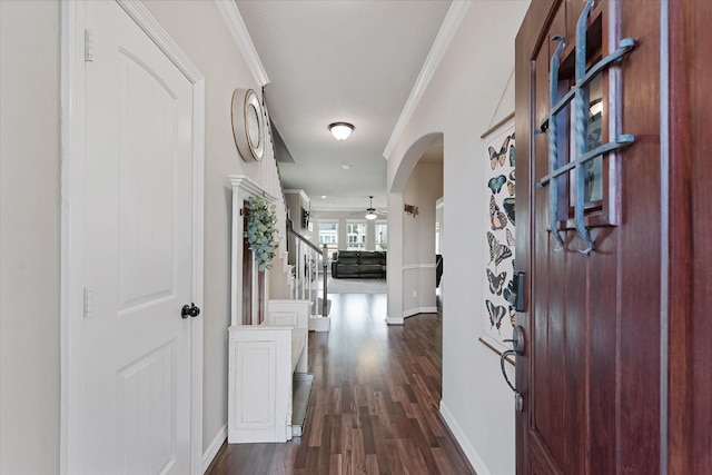 10744 S Lake Mist Ln, Willis, TX 77318 - entrance foyer with dark wood finished floors, a ceiling fan, baseboards, arched walkways, and ornamental molding