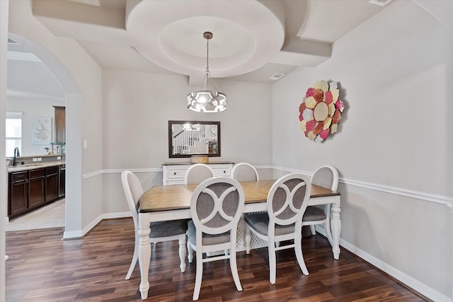 10744 S Lake Mist Ln, Willis, TX 77318 - dining area with arched walkways, light wood-style floors, a chandelier, and baseboards