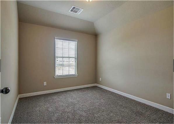 10744 S Lake Mist Ln, Willis, TX 77318 - carpeted empty room featuring baseboards