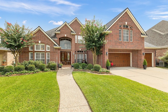5819 Desert Oak Way, Spring, TX 77379 - view of front of home with brick siding, driveway, a front yard, and a garage