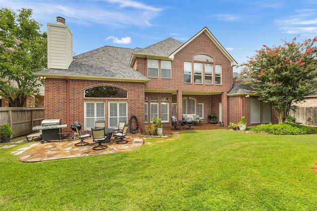 5819 Desert Oak Way, Spring, TX 77379 - rear view of property featuring a patio area, brick siding, a shingled roof, and a chimney