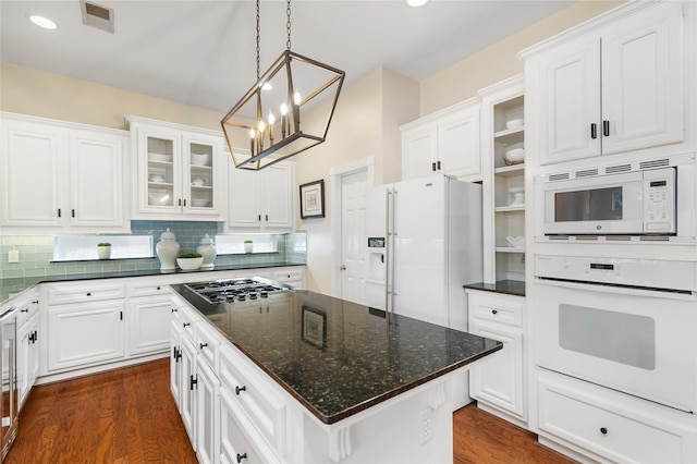 5819 Desert Oak Way, Spring, TX 77379 - kitchen with white appliances, a chandelier, white cabinetry, dark wood-type flooring, and recessed lighting