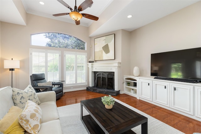 5819 Desert Oak Way, Spring, TX 77379 - living area with wood finished floors, a ceiling fan, crown molding, a premium fireplace, and recessed lighting