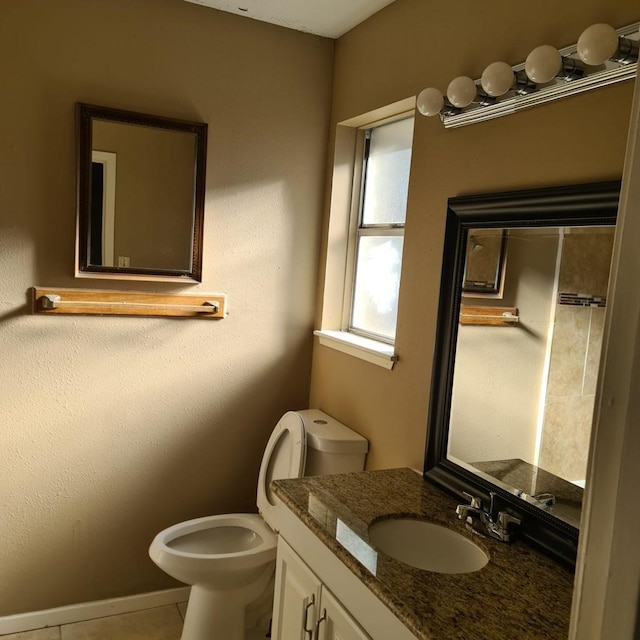 1229 Ramona St, Angleton, TX 77515 - bathroom featuring toilet, vanity, tile patterned flooring, and baseboards