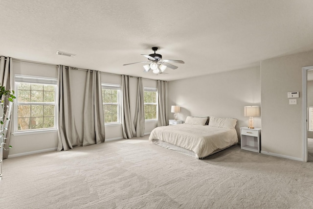 6010 Twin Crk, Missouri City, TX 77459 - bedroom with carpet, baseboards, a ceiling fan, and a textured ceiling