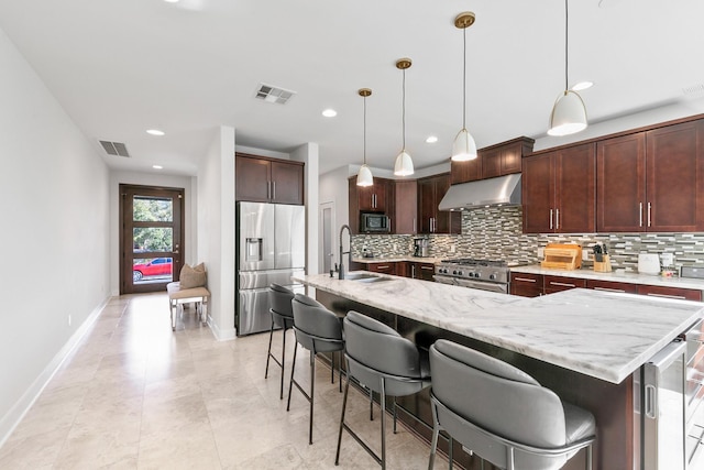 4301 Vivian St, Bellaire, TX 77401 - kitchen featuring stainless steel appliances, a sink, under cabinet range hood, tasteful backsplash, and recessed lighting