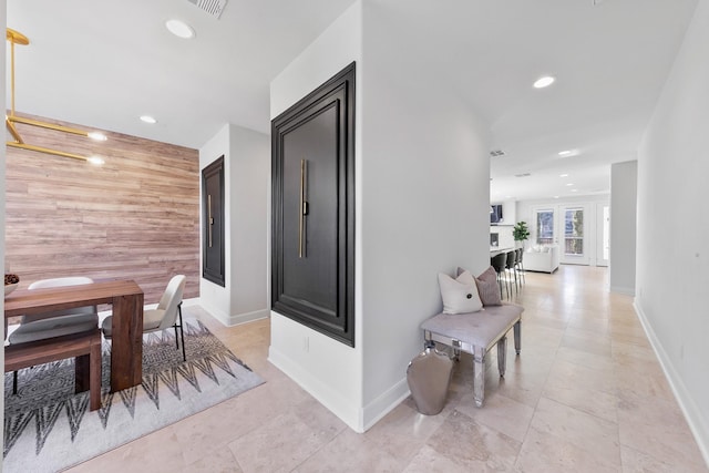 4301 Vivian St, Bellaire, TX 77401 - hallway with recessed lighting, baseboards, an accent wall, and light tile patterned floors