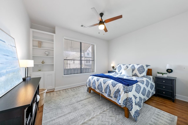 4301 Vivian St, Bellaire, TX 77401 - bedroom with wood finished floors, baseboards, and a ceiling fan