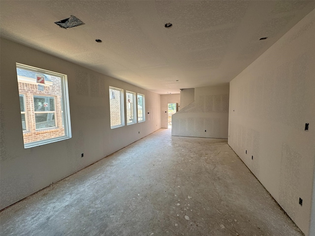 19111 Hazel Firs Ln, Magnolia, TX 77355 - spare room featuring unfinished concrete floors and a textured ceiling