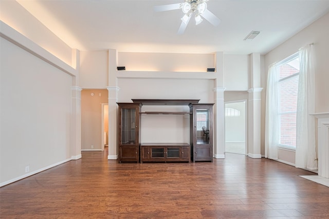 11606 Canyon Breeze Dr, Tomball, TX 77377 - unfurnished living room featuring ceiling fan, wood finished floors, baseboards, and ornate columns