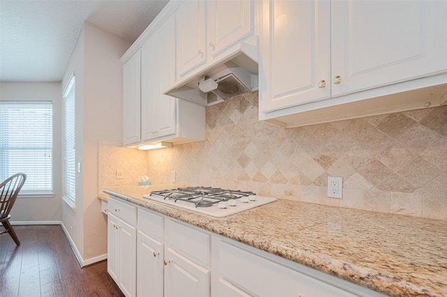 11606 Canyon Breeze Dr, Tomball, TX 77377 - kitchen with white gas stovetop, baseboards, white cabinets, and decorative backsplash