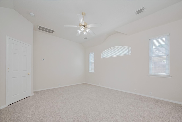 11606 Canyon Breeze Dr, Tomball, TX 77377 - empty room featuring lofted ceiling, ceiling fan, healthy amount of natural light, light colored carpet, and baseboards