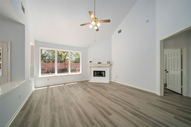 2111 Scenic Hollow Ct, Katy, TX 77450 - unfurnished living room featuring high vaulted ceiling, ceiling fan, wood finished floors, a fireplace, and baseboards