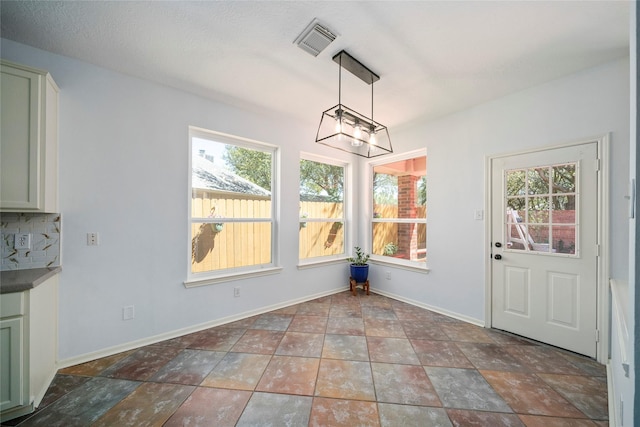 2111 Scenic Hollow Ct, Katy, TX 77450 - unfurnished dining area featuring a chandelier, baseboards, and stone finish floors
