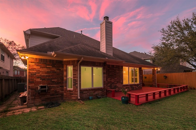 2111 Scenic Hollow Ct, Katy, TX 77450 - back of house at dusk featuring a chimney, cooling unit, brick siding, and roof with shingles