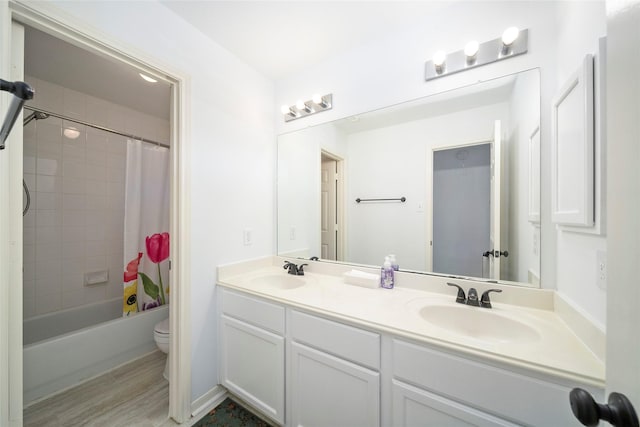 2111 Scenic Hollow Ct, Katy, TX 77450 - full bath featuring toilet, double vanity, shower / bath combination with curtain, and wood finished floors