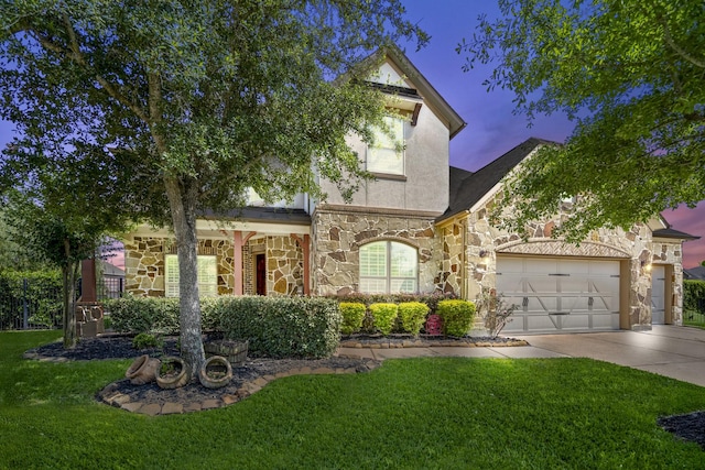 20103 Kirkstone Terrace Ct, Spring, TX 77379 - view of front of house featuring stone siding, a front lawn, concrete driveway, a garage, and stucco siding