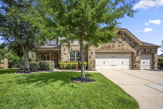 20103 Kirkstone Terrace Ct, Spring, TX 77379 - view of front of home with stone siding, concrete driveway, an attached garage, and a front yard
