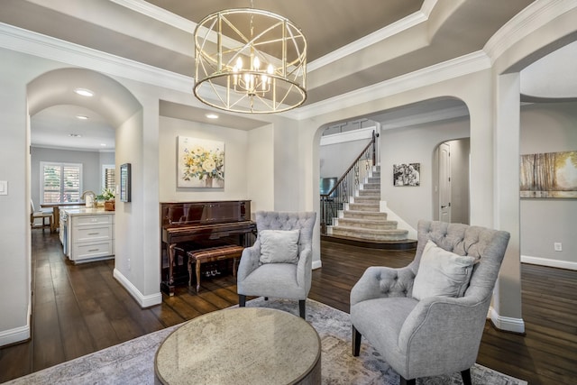 20103 Kirkstone Terrace Ct, Spring, TX 77379 - sitting room with arched walkways, dark wood finished floors, stairs, baseboards, and ornamental molding