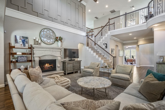 20103 Kirkstone Terrace Ct, Spring, TX 77379 - living room featuring a towering ceiling, stairs, a fireplace, dark wood finished floors, and baseboards