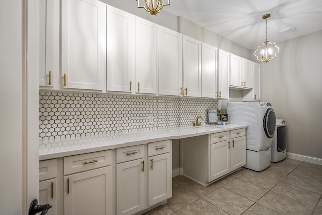 20103 Kirkstone Terrace Ct, Spring, TX 77379 - laundry area with a chandelier, washing machine and clothes dryer, cabinet space, and light tile patterned floors