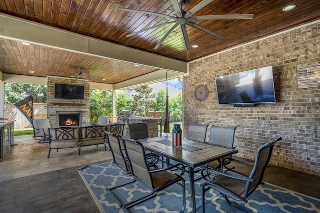 20103 Kirkstone Terrace Ct, Spring, TX 77379 - view of patio / terrace with a ceiling fan, an outdoor stone fireplace, outdoor dining space, and an outdoor kitchen