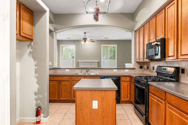 10446 Antelope Aly, Missouri City, TX 77459 - kitchen featuring black appliances, a sink, arched walkways, and light tile patterned flooring