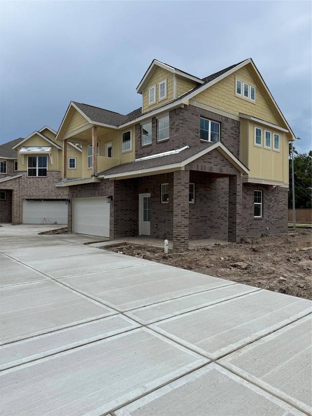 15867 Invergelder Dr, Atascocita, TX 77346 - view of front facade featuring a garage, driveway, and brick siding
