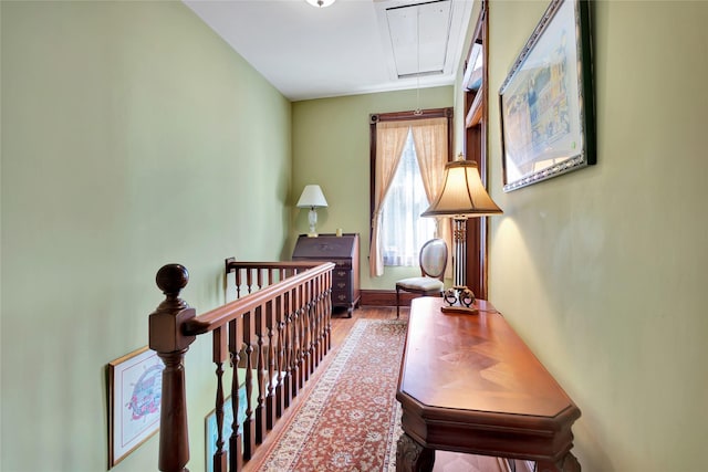 2608 Ursuline St, Galveston, TX 77550 - hall with attic access, wood finished floors, and baseboards