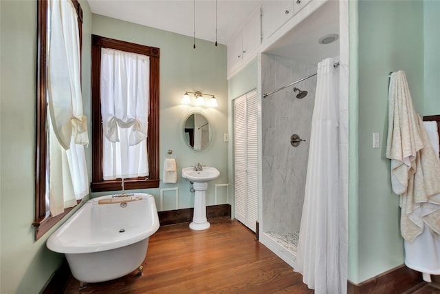 2608 Ursuline St, Galveston, TX 77550 - full bath with a tile shower, a freestanding tub, wood finished floors, and baseboards