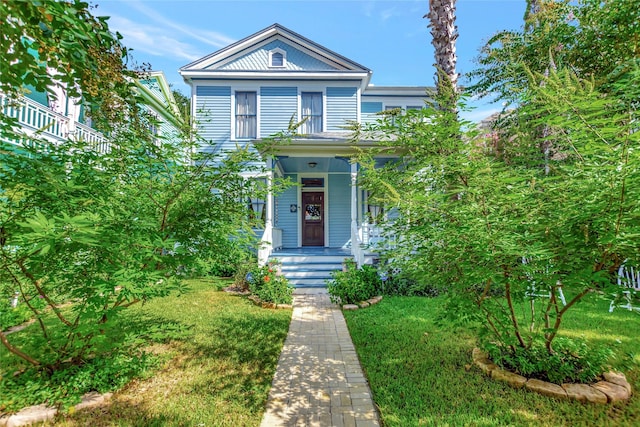 2608 Ursuline St, Galveston, TX 77550 - view of front facade with a front lawn and a porch