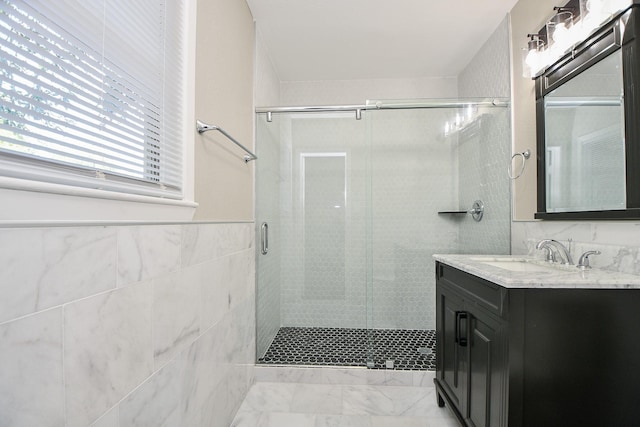 1225 Kirsten St, Galveston, TX 77568 - full bathroom with a stall shower, vanity, marble look tiles, and tile walls
