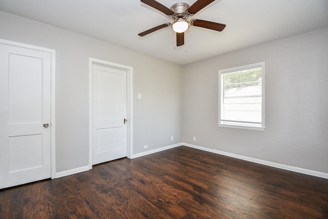 1225 Kirsten St, Galveston, TX 77568 - unfurnished bedroom with baseboards, dark wood finished floors, and ceiling fan