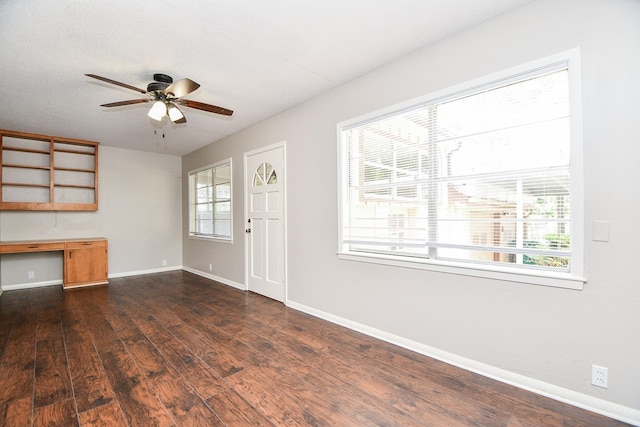 1225 Kirsten St, Galveston, TX 77568 - unfurnished living room featuring ceiling fan, dark wood-style floors, and baseboards