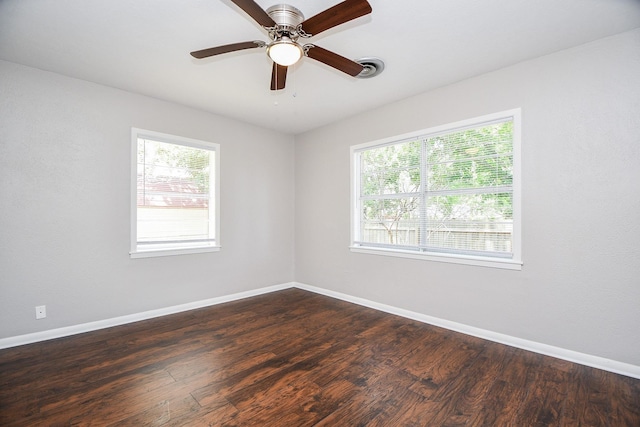 1225 Kirsten St, Galveston, TX 77568 - unfurnished room with plenty of natural light, baseboards, dark wood-style floors, and a ceiling fan