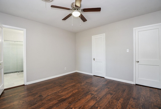 1225 Kirsten St, Galveston, TX 77568 - unfurnished bedroom with dark wood-style flooring, baseboards, ensuite bath, and a ceiling fan