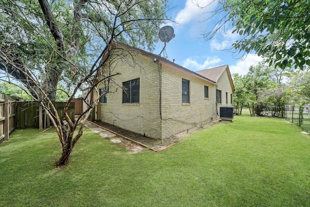 1225 Kirsten St, Galveston, TX 77568 - view of side of property featuring cooling unit and brick siding