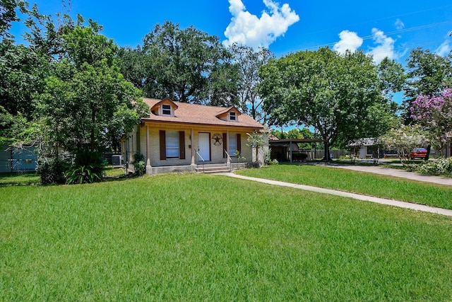 1225 Kirsten St, Galveston, TX 77568 - view of front of home with a front yard, a porch, brick siding, and driveway